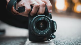 Person holding DSLR camera close up photographer