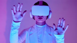 person wearing VR headset with hands raised during gameplay