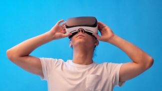Young man wearing VR headset virtual reality glasses